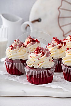 Red velvet cupcakes with cream cheese frosting on a cake stand