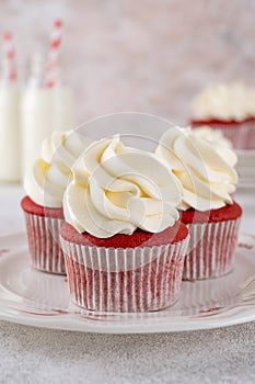 Red velvet cupcakes with cream cheese frosting and red sugar hearts. Delicious dessert for Valentines day. Selective focus