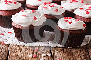 Red velvet cupcakes decorated with hearts close-up. Horizontal