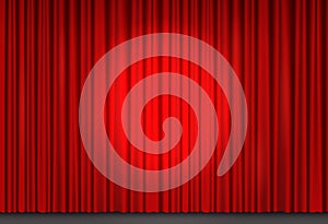 Red velvet curtain in theater with spot of light