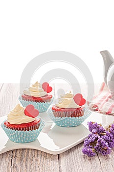 Red velvet heart cupcake with cream cheese frosting and a red heart for Valentine`s Day