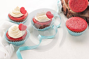 Red velvet heart cupcake with cream cheese frosting and a red heart for Valentine`s Day