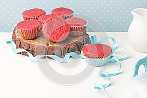 Red velvet heart cupcakes with cream cheese frosting and a red heart for Valentine`s Day. Top view with copy space