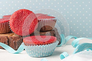 Red velvet heart cupcakes with cream cheese frosting and a red heart for Valentine`s Day. Top view with copy space
