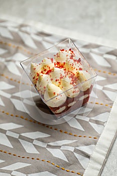 Red Velvet Mousse Jar isolated on napkin side view of cafe baked food on background