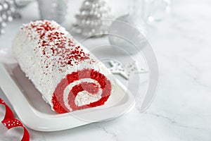 Red Velvet roll cake for Christmas with cream cheese and coconut flakes