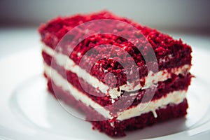 Red velvet slice of cake on white plate