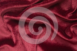 Red velvet texture abstract background. Fashion textile backdrop Holiday design material with waves