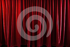 red velvet theater curtains close up with glowing lights