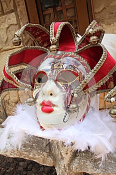 Red Venetia Mask on Rock