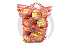 Red vertical standing string bag of apples