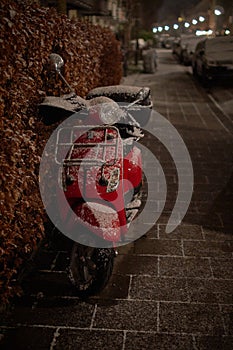 Red vespa on a cold winter evening
