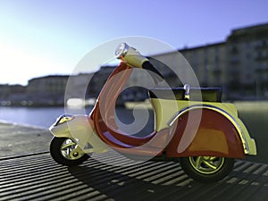 Red vespa model parked on the side of Darsena pier in Milan Italy photo