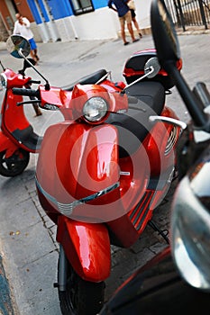 Red vespa motorcycle reminiscent of italy