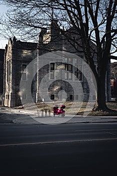 Red Vespa parked in front of the old building