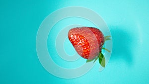 Red vibrant strawberries floating on the water