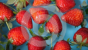 Red vibrant strawberries floating on the water