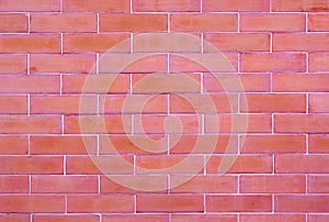 Close-up the reddish brown brick wall rough blocks, texture and background.