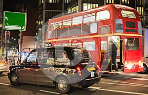 Red vintage bus and classic style taxi in London.
