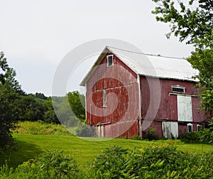 Red vintage country barn with gable roof