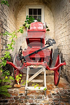 Red vintage horse carriage/ horse drawn buggy wagon.