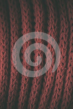 Red vintage knitted fabric texture and background for designers. Vintage knitted background. Close up view of red abstract texture