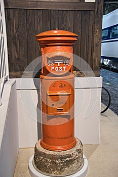 A red vintage mail post setting as display.