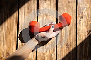 Red vintage phone handset in a woman`s hand.