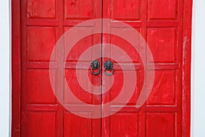 Red vintage retro wooden door on white wall background. Home interior architecture design, plain tropical textured wood panel