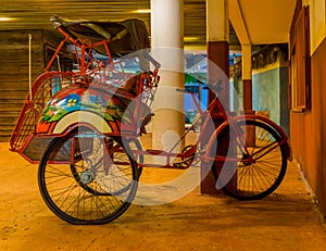 Red vintage ricksha, traditional cycle rickshaw, Vintage transportation vehicle from Asia