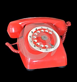 Red vintage telephone isolated on black background