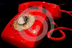 Red vintage telephone isolated on black background..Old fashioned red phone on background.classic red telephone photo
