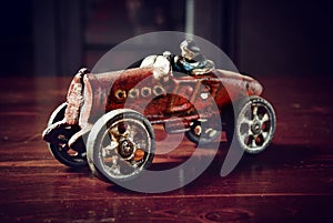 Red vintage toy car on dark wooden table