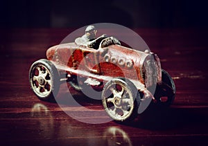 Red vintage toy car on dark wooden table