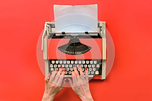 Red vintage typewriter with white blank paper sheet