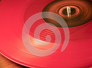 A Red Vynil Disc is being played