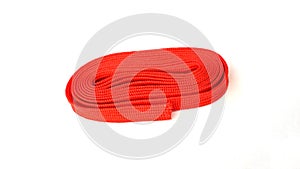 Red vinyl rope on white background. Fabric rope in red color folded in a coil