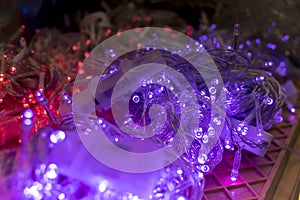 Red and violet LED Christmas string lights for sale at a department store