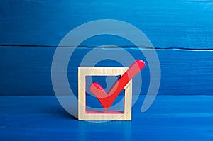 Red voting check mark on a blue background. Voting concept for democratic elections. Make the best choice, solve the problem