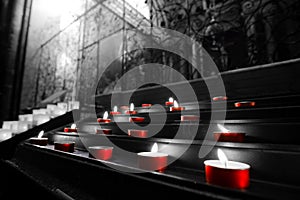 Red votive candles church tealights selective color black and white