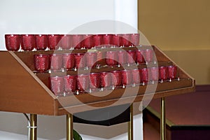 Red votive offertory candles in a catholic church