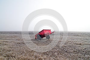 Red wagon and field in fog