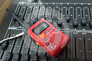 A red walkie-talkie on switchboard controller
