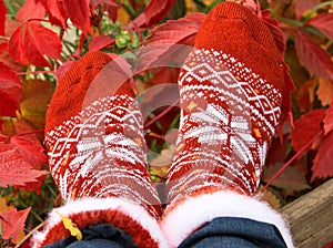 Red warm socks with a pattern on the grass