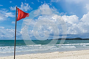 Red warning flag on the beach