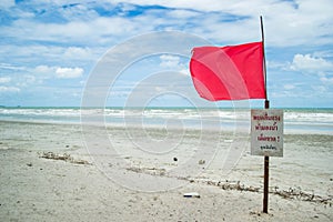 Red warning flag on the beach