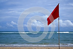 A red warning flag on the beach in the Nuca Dua Bali