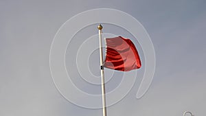 Red warning flag fluttering