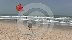 Red warning flag flying on a desert