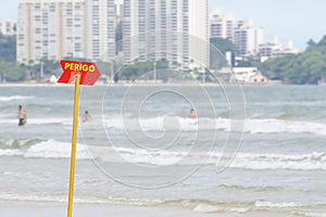 Red warning sign at the beach